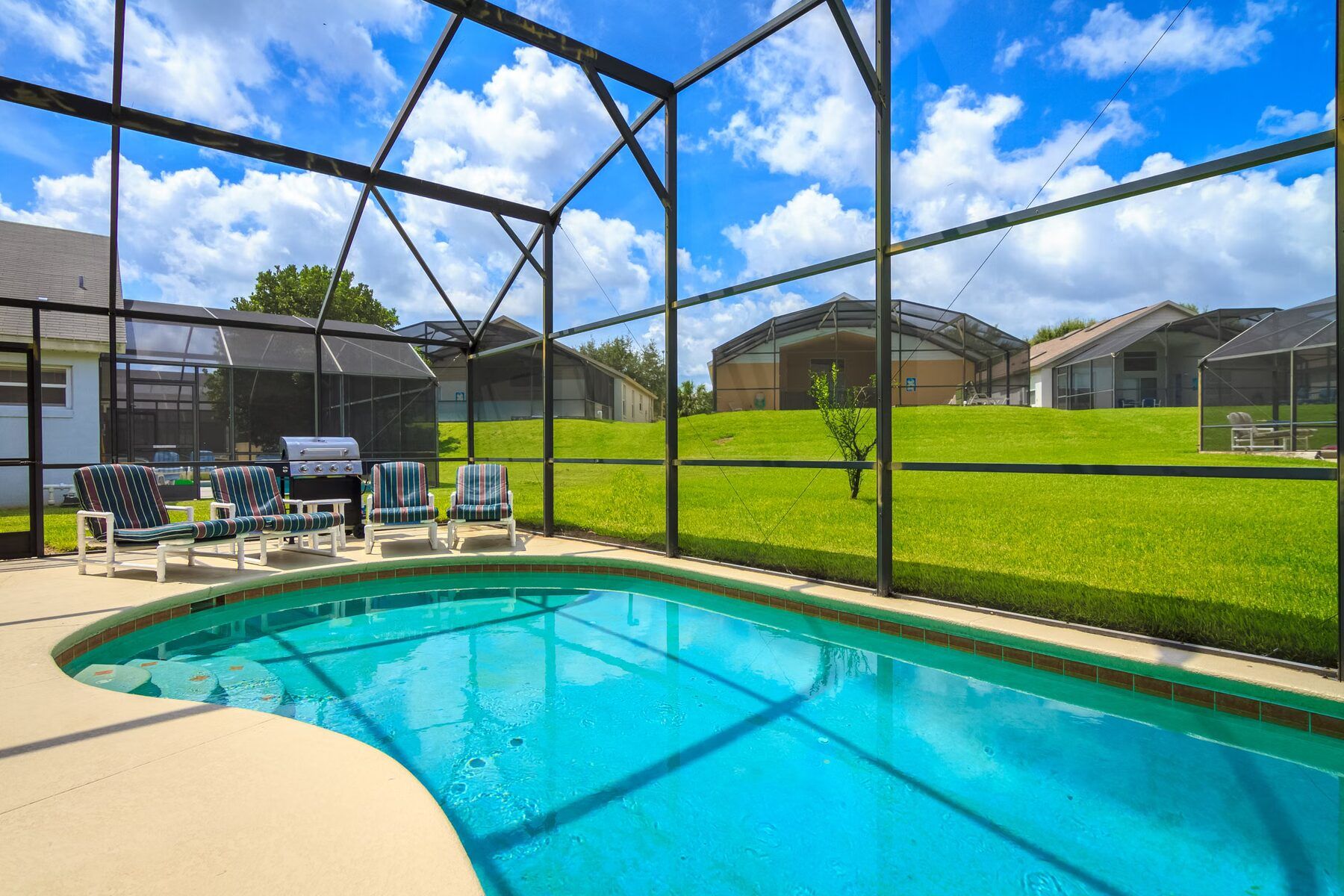 Screen-enclosed backyard pool at a Florida home