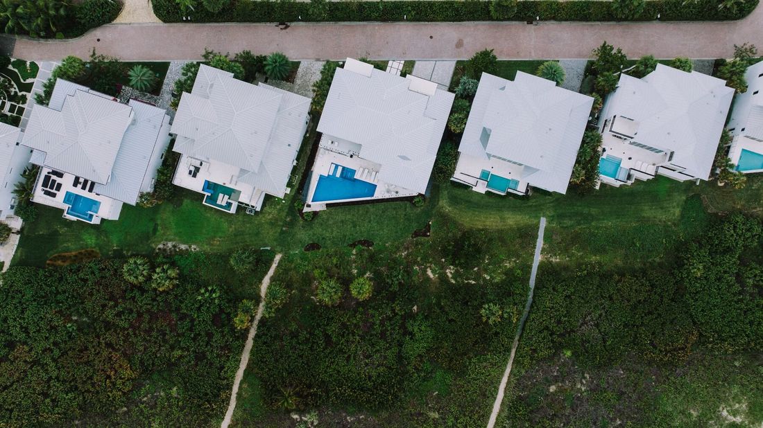 Aerial view of backyard pools in a Florida neighborhood